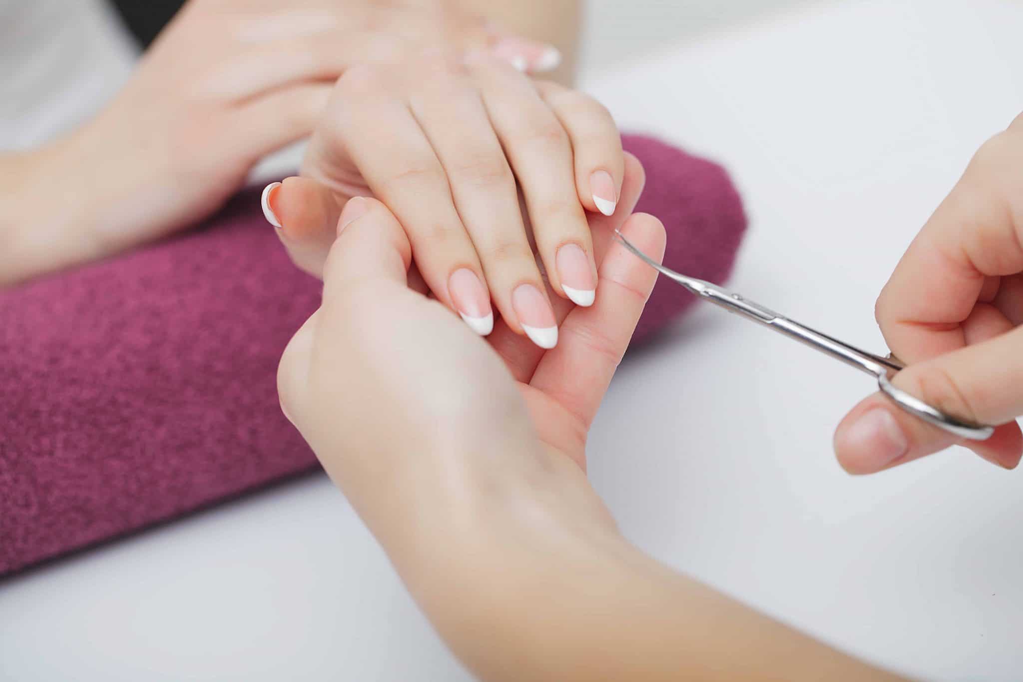 woman-hands-nail-salon-receiving-manicure-procedure